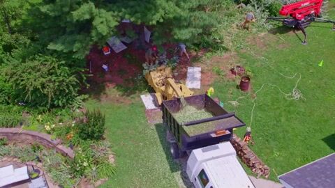 Drone footage looking straight down as chip is blown into the truck box
